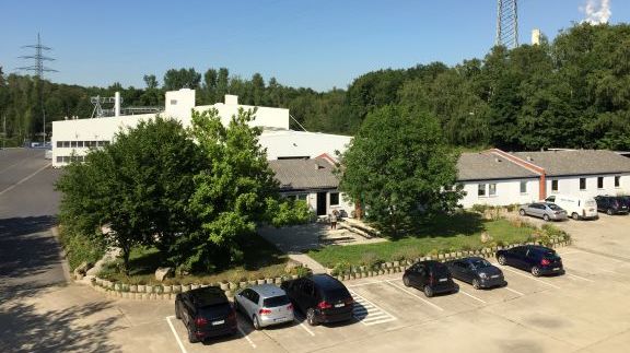 exterior view of the production site with parking area and administrative buildings of humintech company