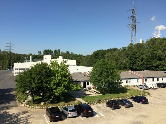 exterior view of the production site with parking area and administrative buildings of humintech company